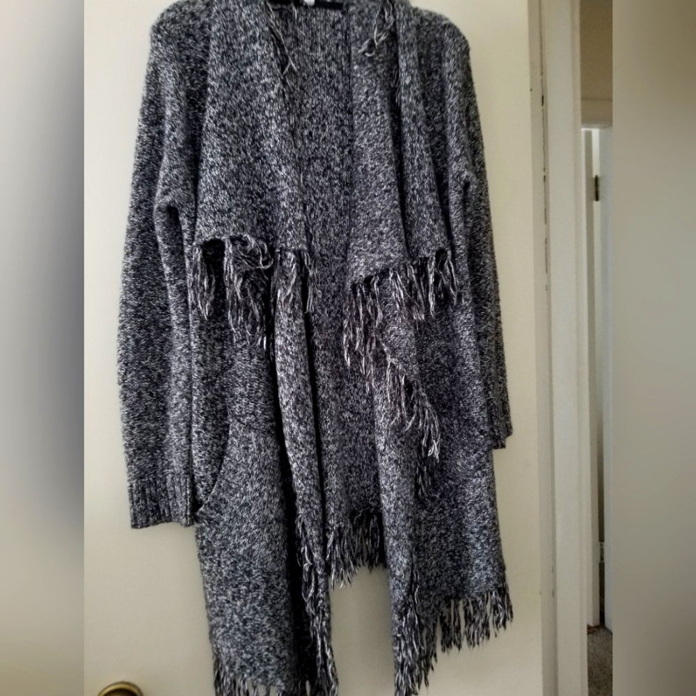 Medium Large sweater in black and white with fringe.